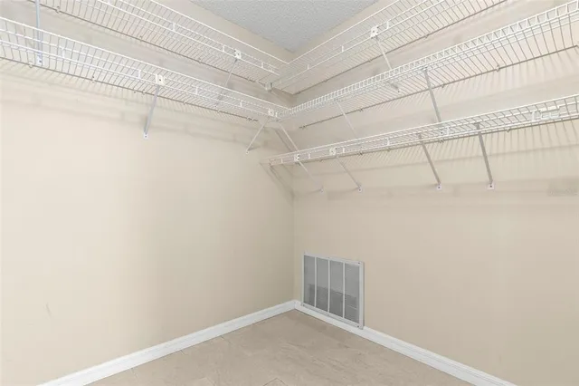 a spacious bathroom with a sink a toilet and a mirror