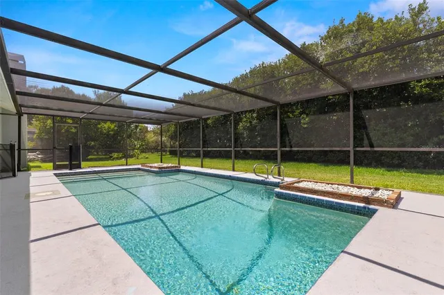 a view of a backyard with swimming pool