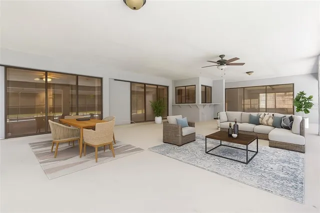 a view of an empty room with a floor to ceiling window and a flat screen tv