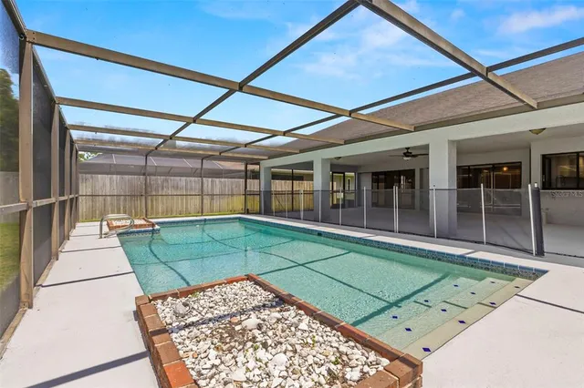 a backyard of a house with table and chairs