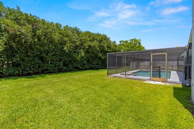 a view of a house with backyard and sitting area