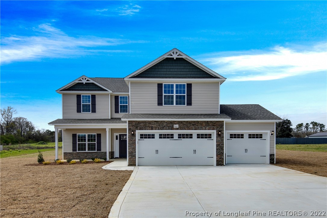 2605 Riddle Farm Hope Mills, NC 28348 - Photo 1 of 50 a front view of a house with a yard