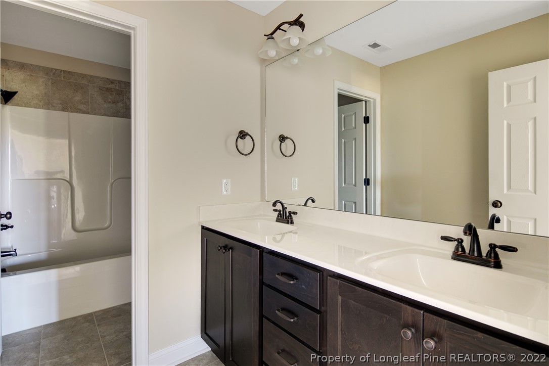 2605 Riddle Farm Hope Mills, NC 28348 - Photo 36 of 50 a bathroom with a sink and a mirror