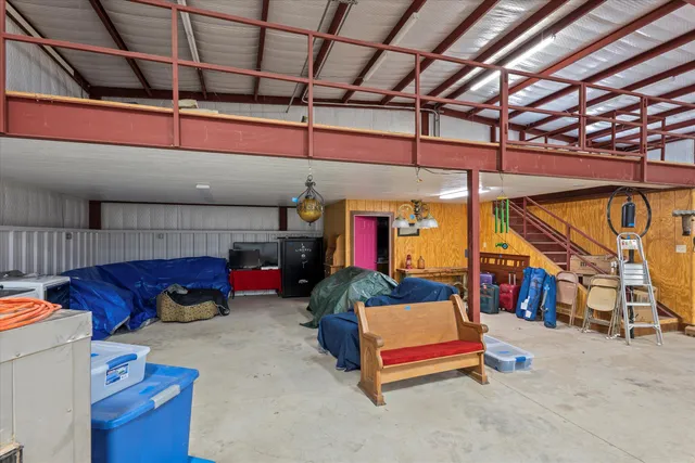a living room with furniture gym equipment and a large window