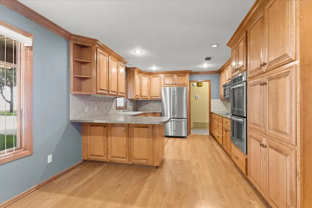 a kitchen with stainless steel appliances granite countertop a refrigerator sink and cabinets