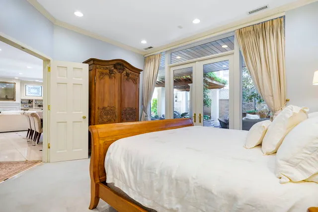 a bedroom with a bed and a mirror