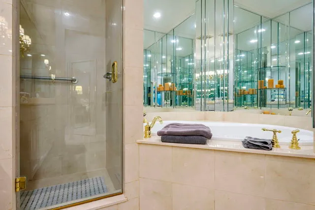 a bathroom with shower and a tub