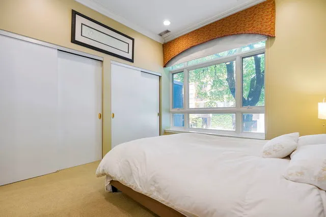 a bed sitting in a bedroom next to a window