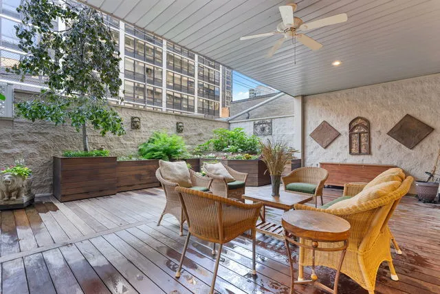 a view of a patio with table and chairs potted plants with wooden floor
