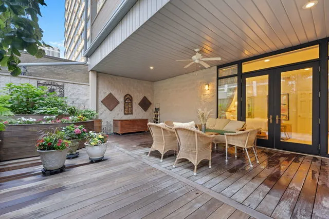 a view of a patio with table and chairs potted plants with wooden floor