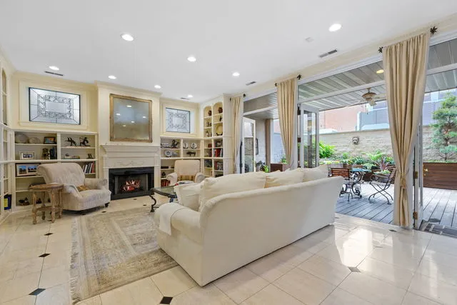 a living room with furniture a large window and a fireplace