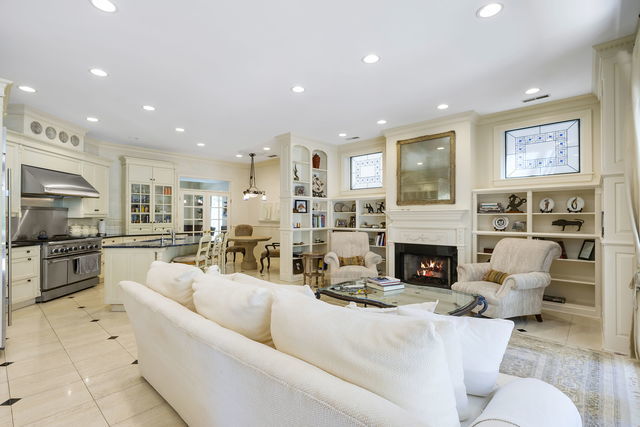 45 East Cedar Street, Unit 200 Chicago, IL 60611 - Photo 4 of 35 a living room with furniture a fireplace and a open kitchen view