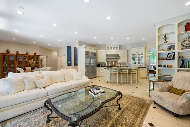 a living room with furniture and kitchen view