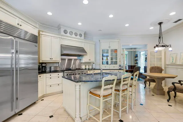 a kitchen with cabinets and chairs