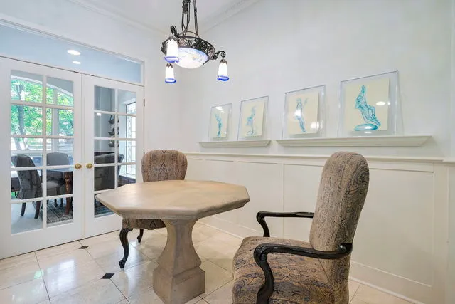 a view of a dining room with furniture and chandelier