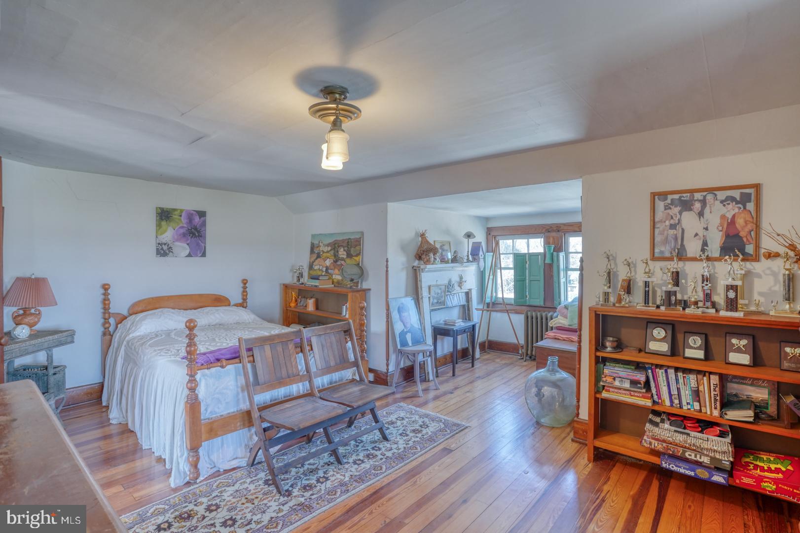 4096 Main Street Trappe, MD 21673 - Photo 58 of 70 a bedroom with furniture and a book shelf