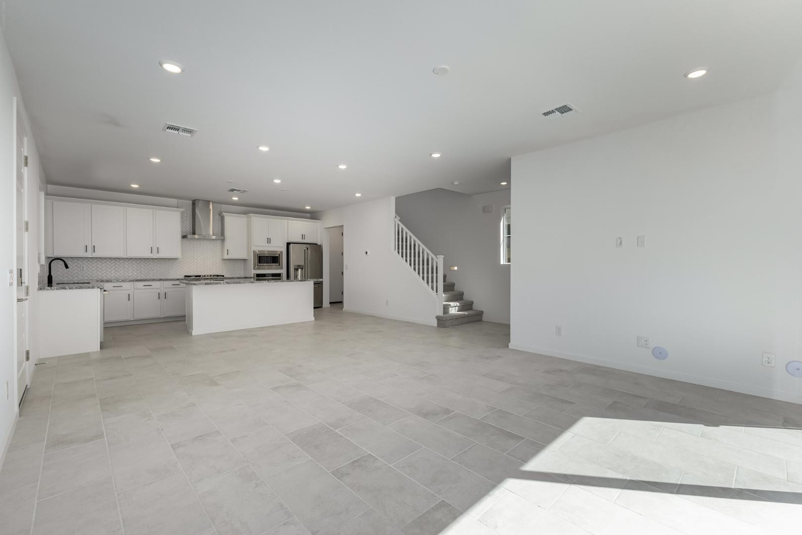 a view of kitchen with kitchen island microwave and cabinets