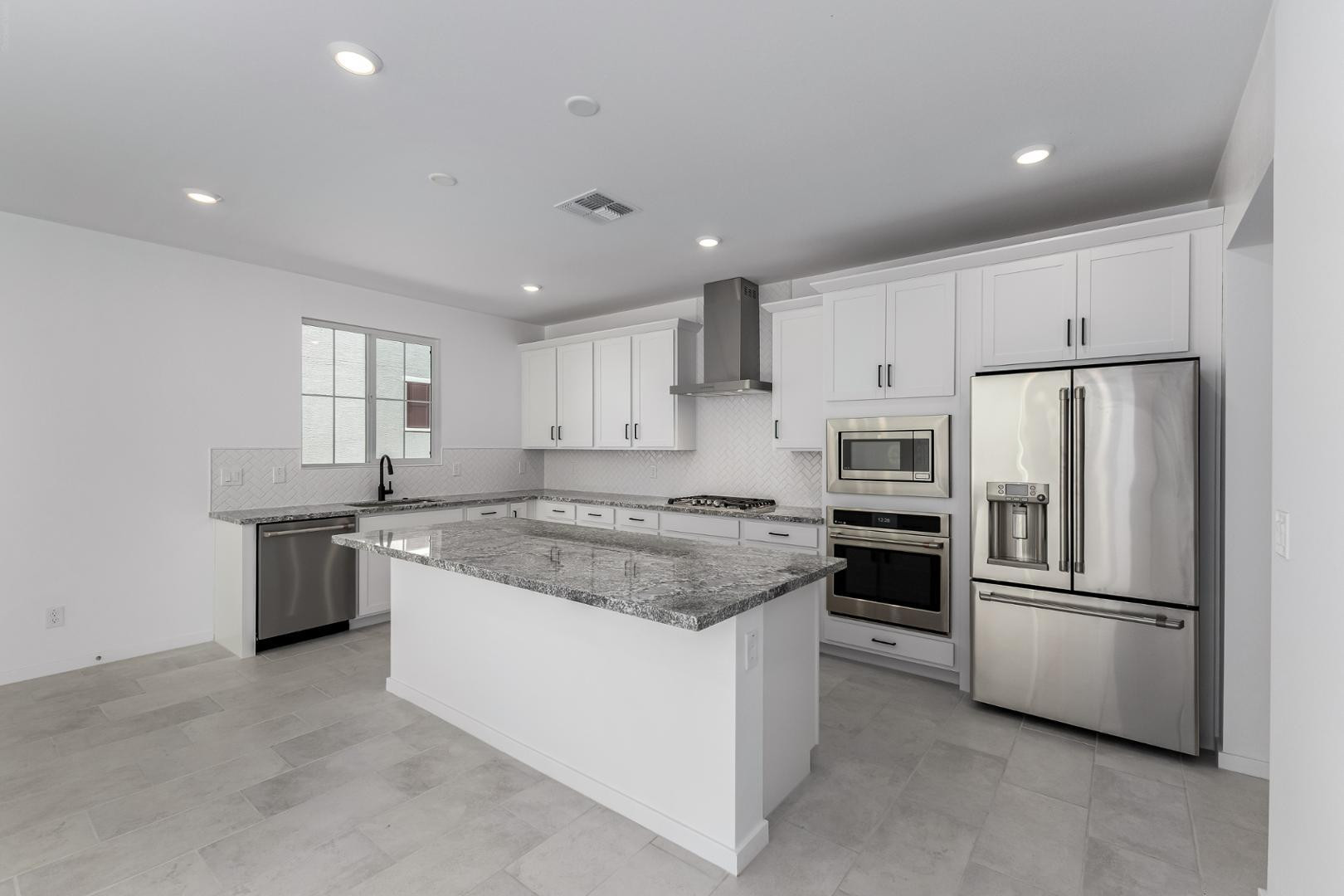 2436 West Maximo Way Phoenix, AZ 85085 - Photo 11 of 37 a kitchen with stainless steel appliances granite countertop a stove a refrigerator and a refrigerator