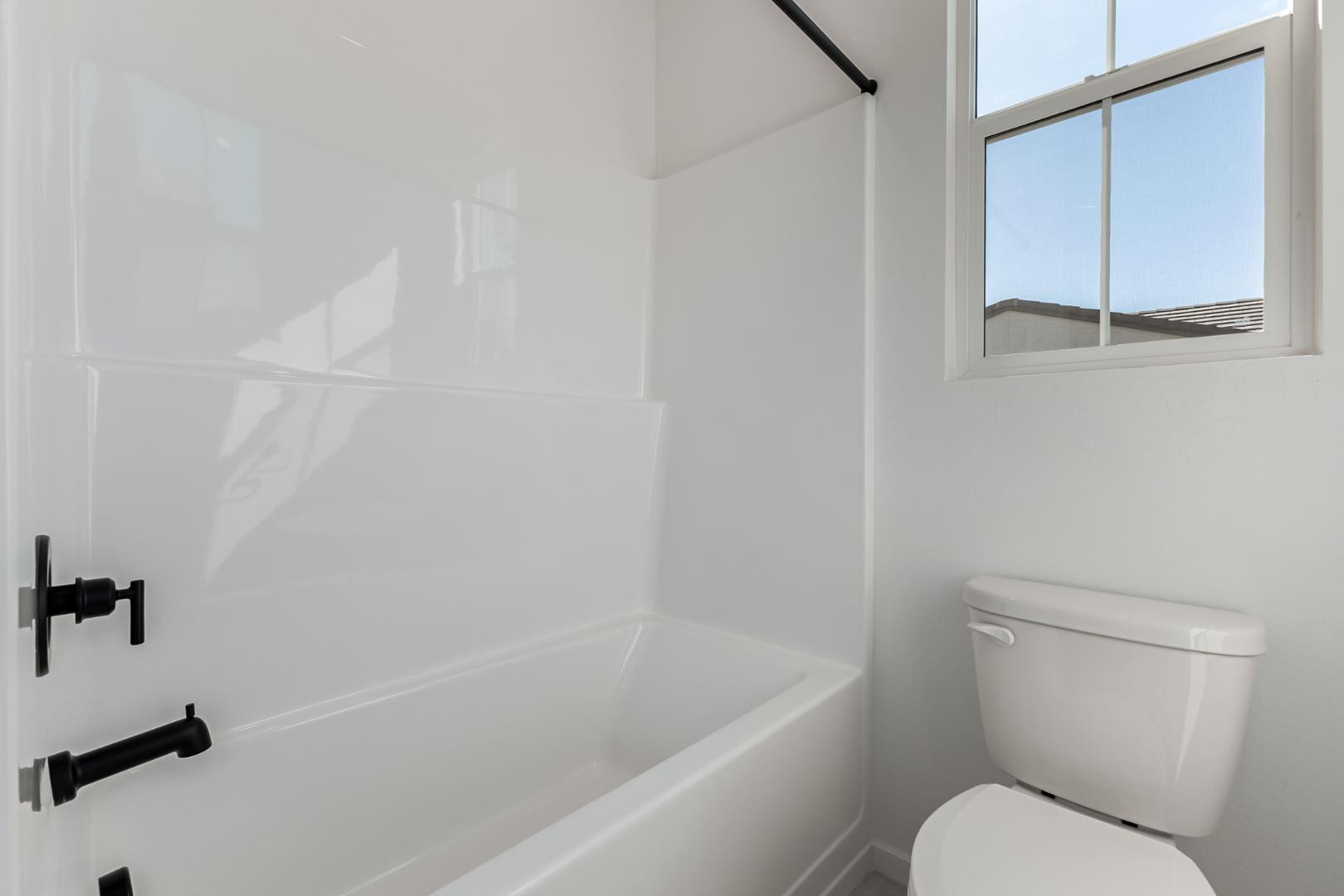 2436 West Maximo Way Phoenix, AZ 85085 - Photo 16 of 37 a white toilet sitting next to a bath tub