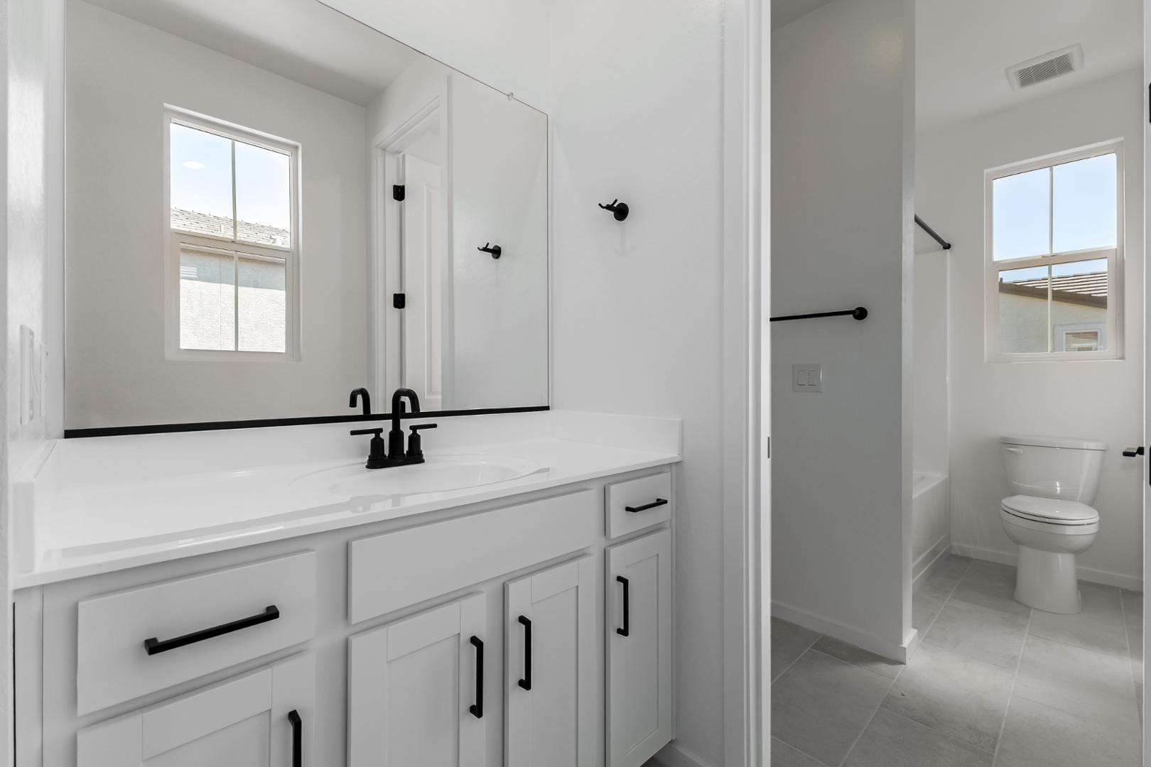2436 West Maximo Way Phoenix, AZ 85085 - Photo 22 of 37 a bathroom with a sink a toilet and a window