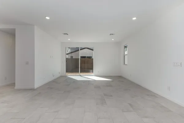 an empty room with a empty space and windows