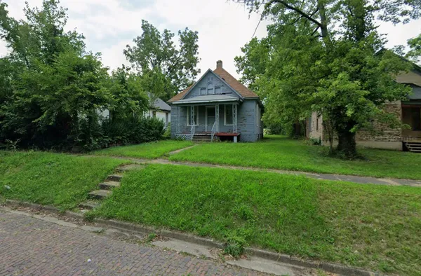 a view of a house with yard and a garden