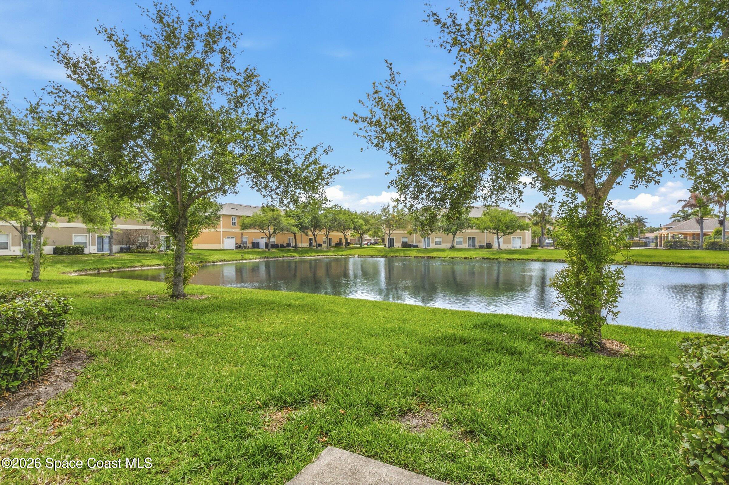 2780 Reston Street, Unit 105 Melbourne, FL 32935 - Photo 11 of 32 a backyard of a house with lots of green space and fountain
