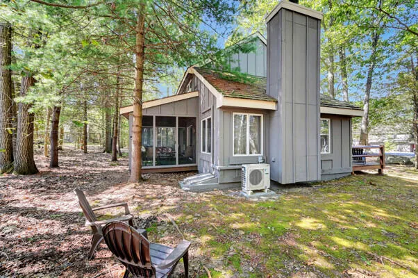 a view of a house with backyard porch and sitting area