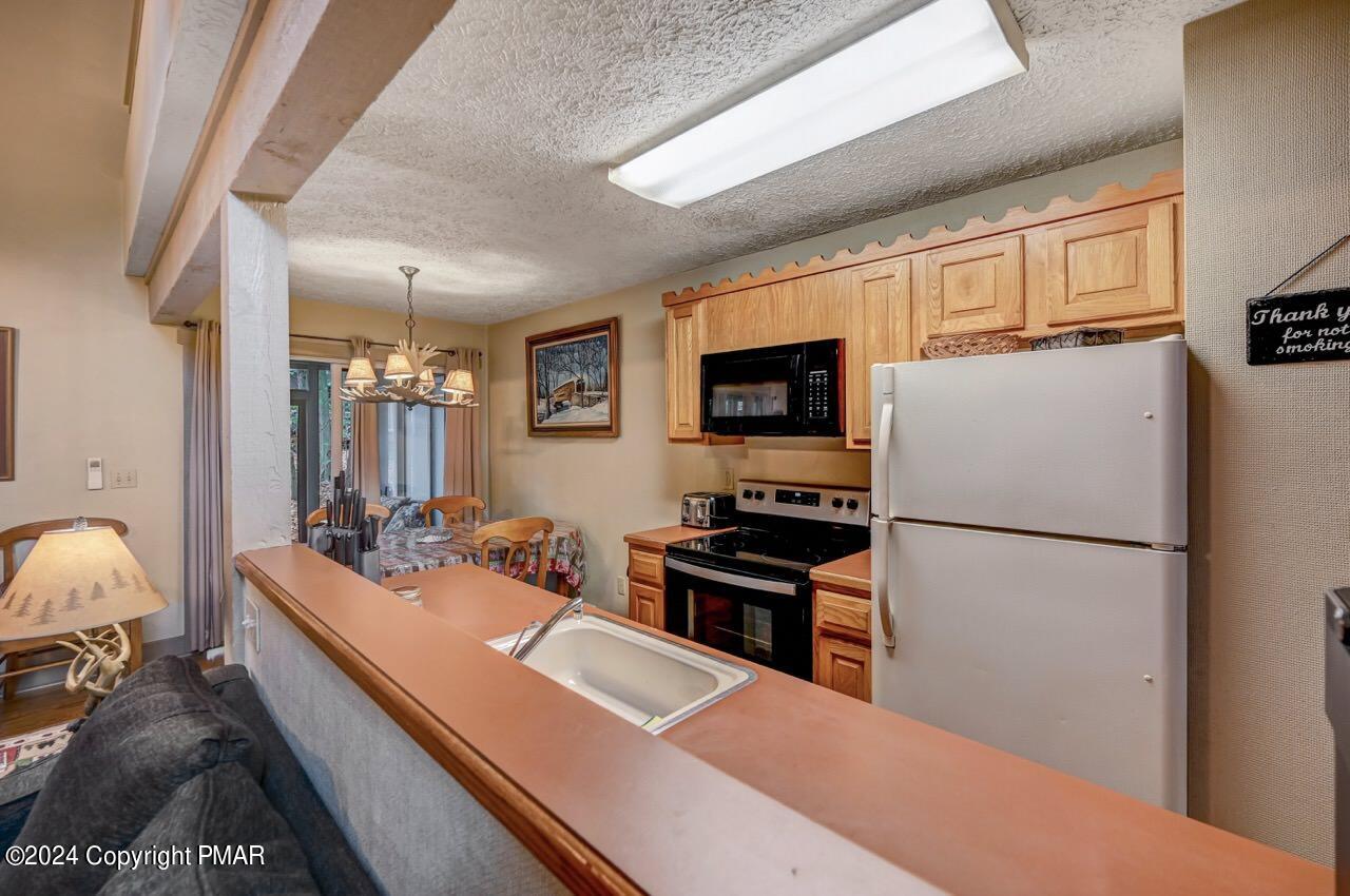 103 Telemark Lake Harmony, PA 18624 - Photo 25 of 68 a room with furniture a flat screen tv and a refrigerator