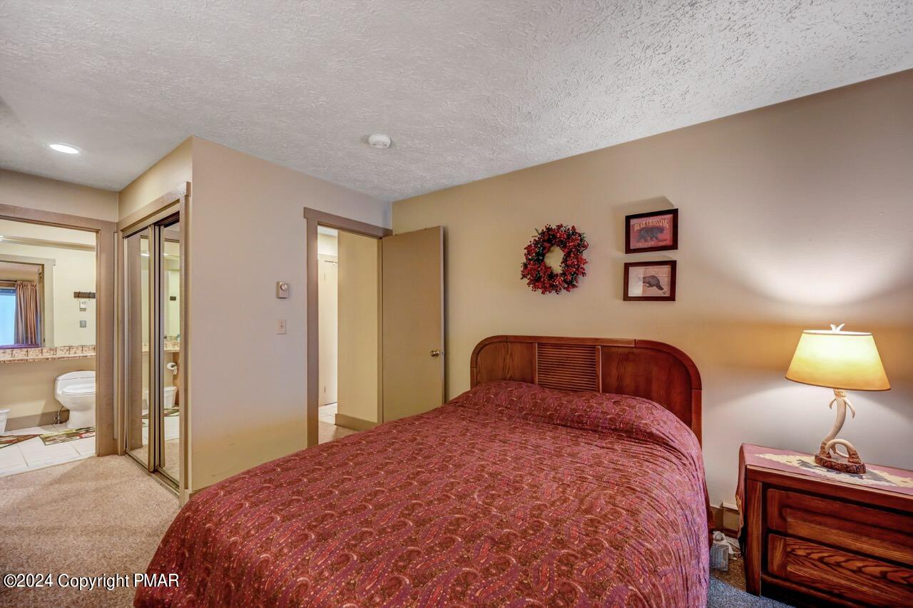 103 Telemark Lake Harmony, PA 18624 - Photo 32 of 68 a bedroom with a bed and a lamp