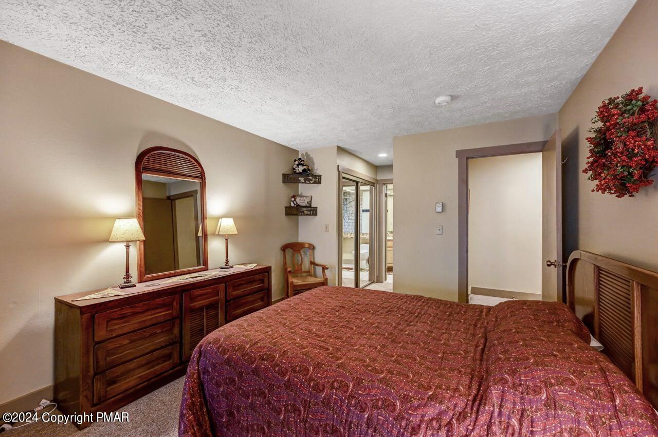 103 Telemark Lake Harmony, PA 18624 - Photo 33 of 68 a bedroom with a bed and a large mirror on dresser