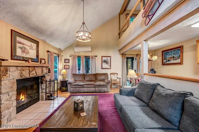 a living room with furniture and a fireplace
