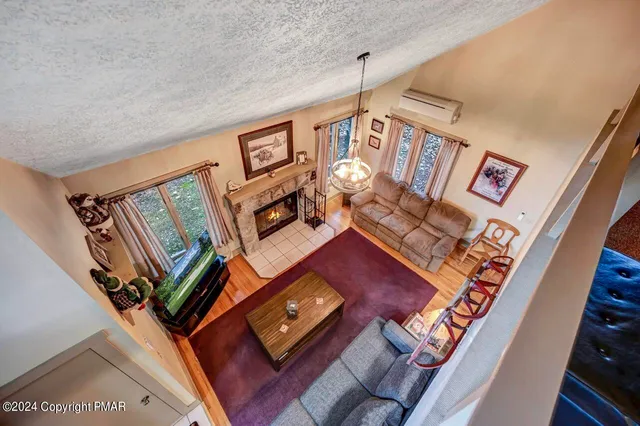 a view of swimming pool with lawn chairs and plants