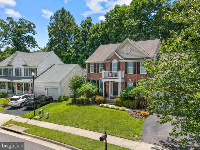 a front view of a house with a yard table and chairs