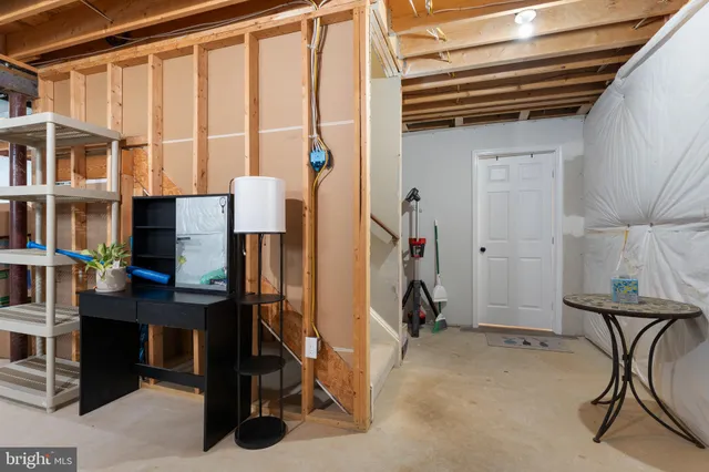 a bedroom with a bed and a television