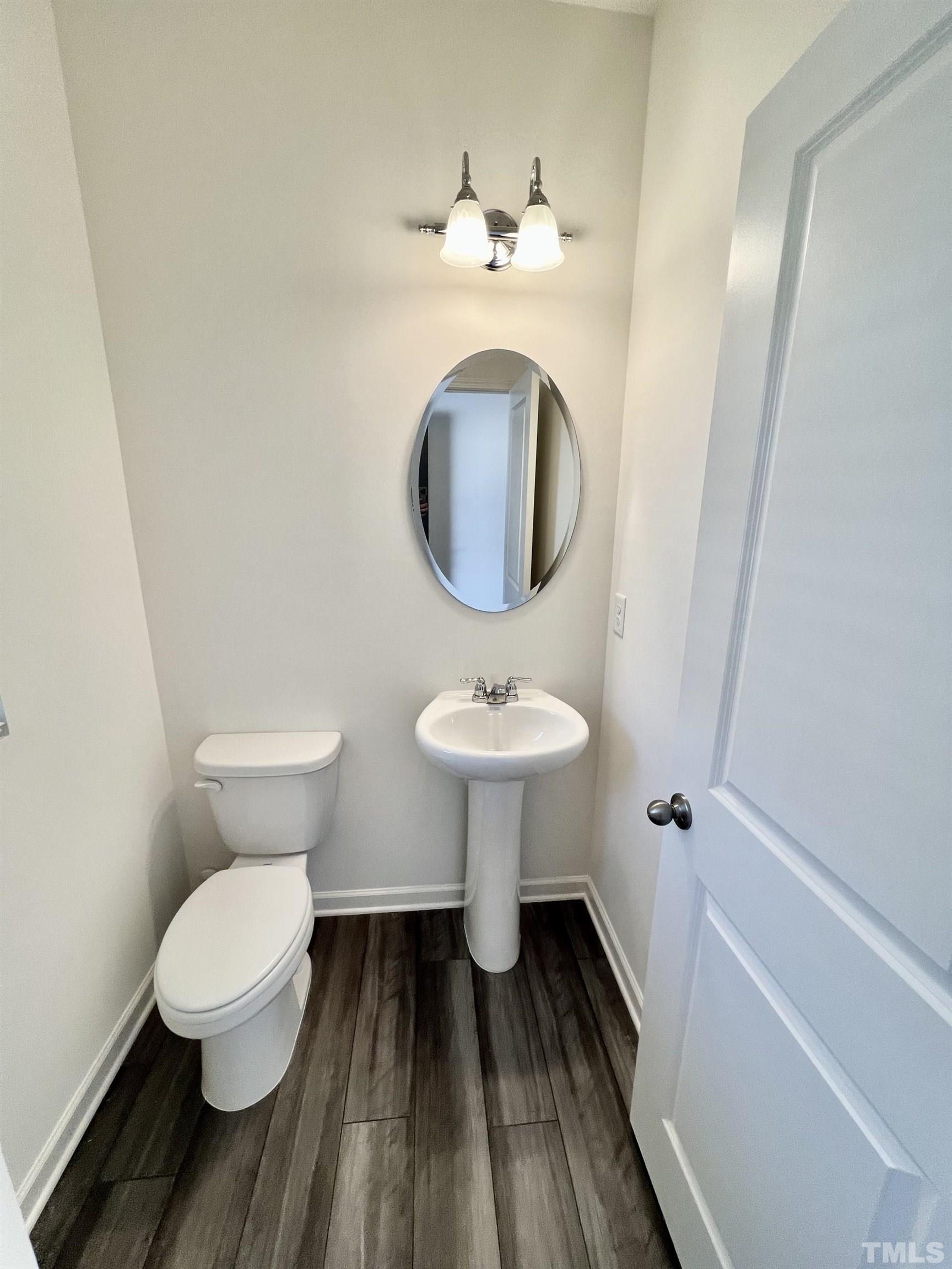 3403 C Walker Drive Wilson, NC 27893 - Photo 11 of 26 a bathroom with a toilet sink and mirror