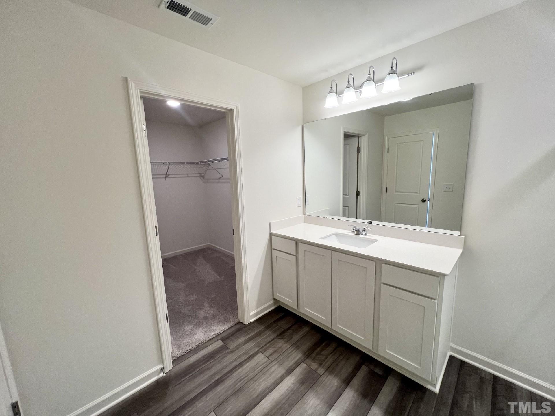3403 C Walker Drive Wilson, NC 27893 - Photo 14 of 26 a bathroom with a double vanity sink and mirror