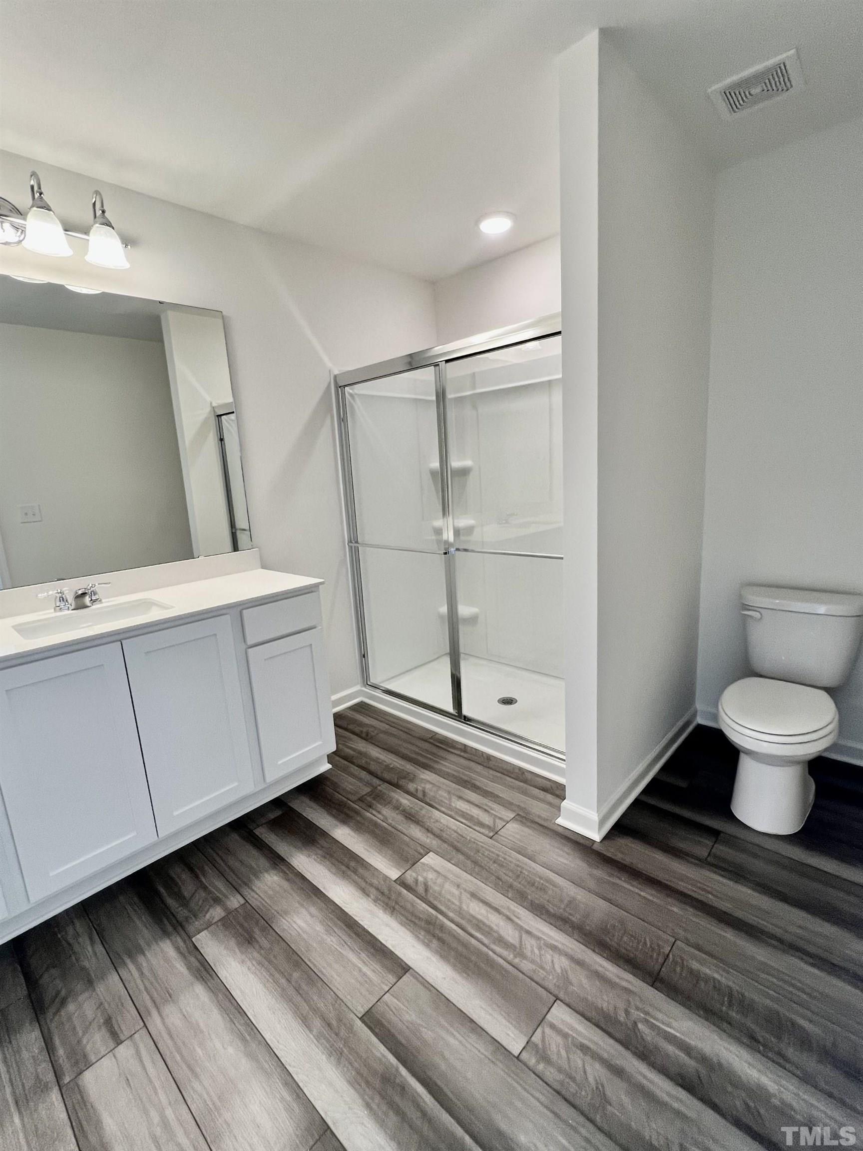 3403 C Walker Drive Wilson, NC 27893 - Photo 15 of 26 a bathroom with a sink a toilet and a mirror