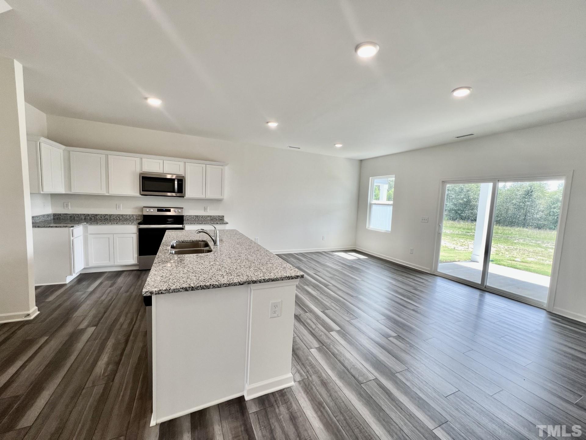 3403 C Walker Drive Wilson, NC 27893 - Photo 6 of 26 a kitchen with granite countertop wooden floors and wide window