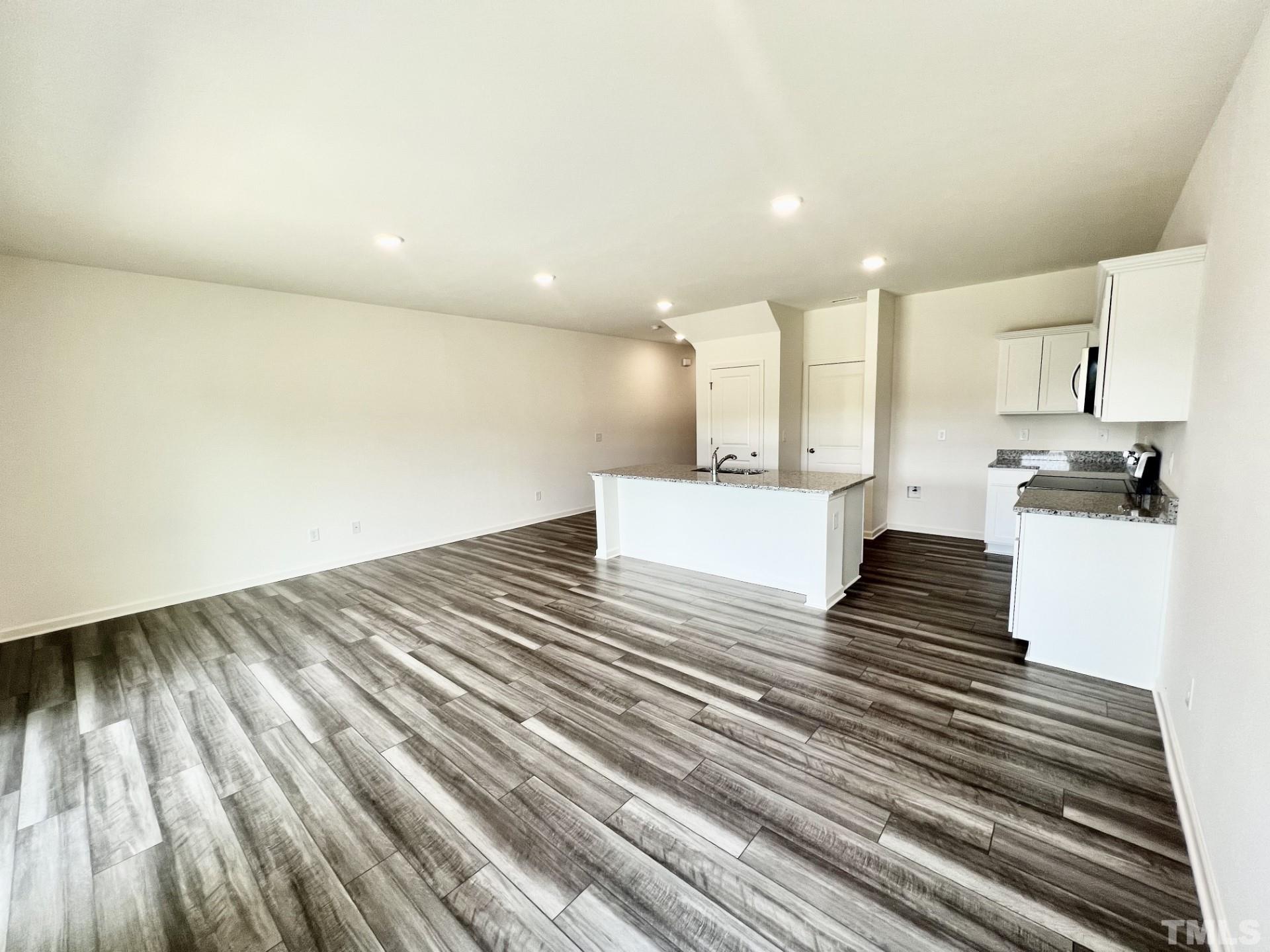 3403 C Walker Drive Wilson, NC 27893 - Photo 9 of 26 a view of kitchen and empty room with wooden floor