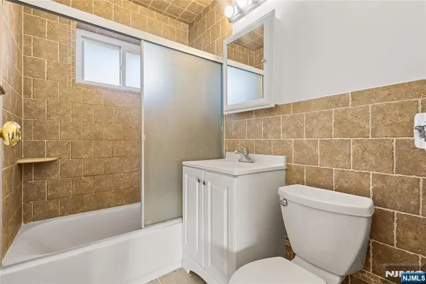 a bathroom with a toilet a sink and bathtub