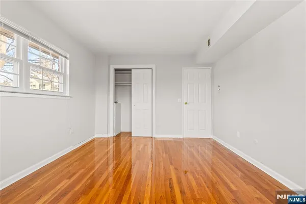 a view of a room with wooden floor and window