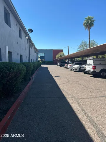 a view of a street with a car parked on the road