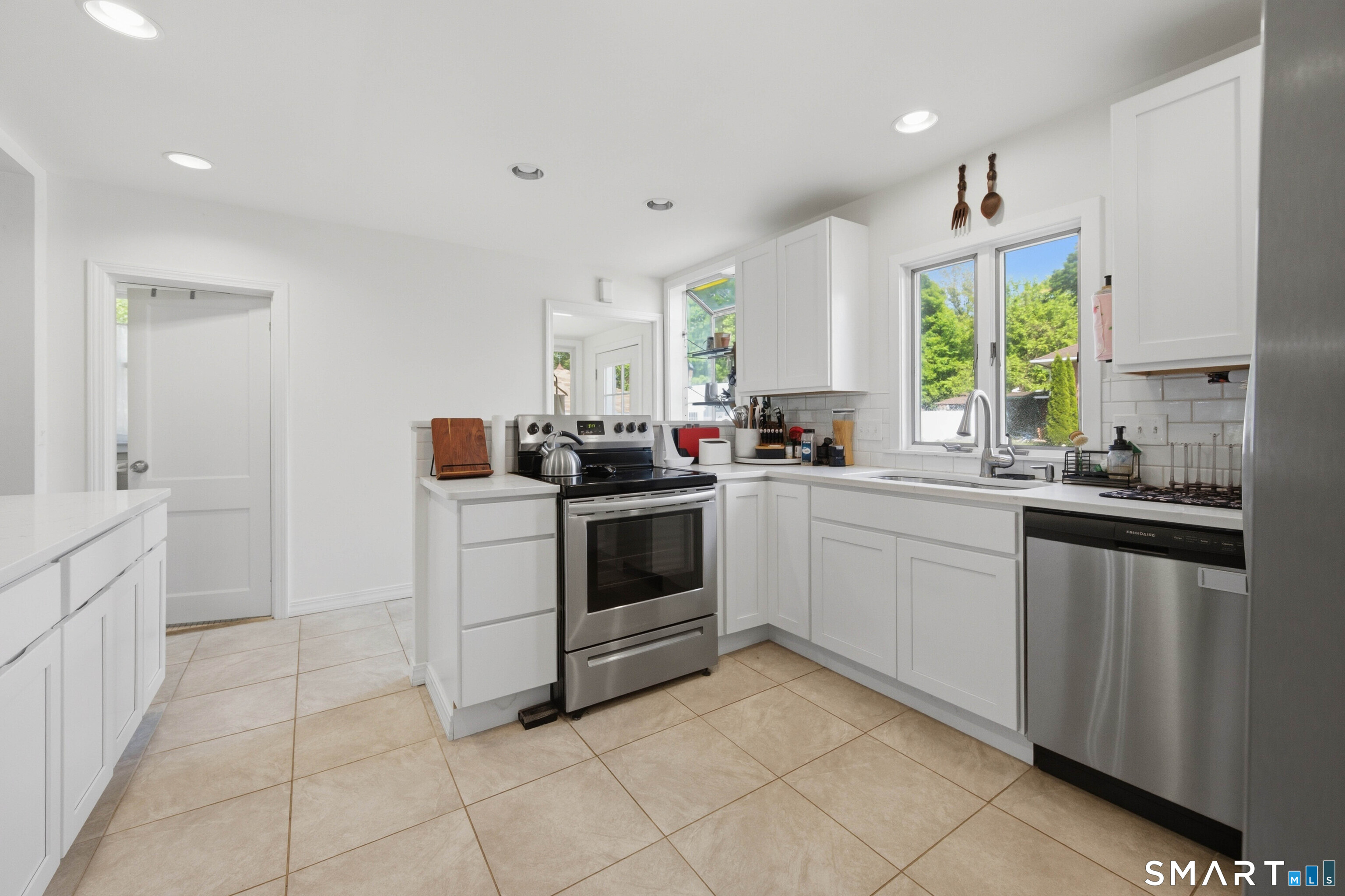 120 May Street Naugatuck, CT 06770 - Photo 5 of 31 a kitchen with a stove a sink and a refrigerator