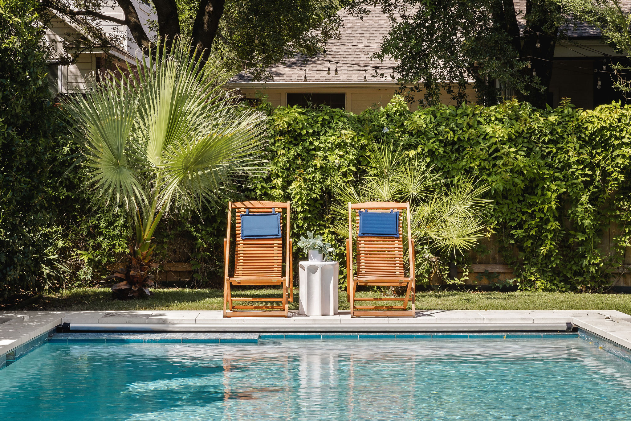 6500 Clay Allison Pass Austin, TX 78749 - Photo 4 of 39 Outdoor swimming pool with integrated hardscaping, surrounded by lush green foliage