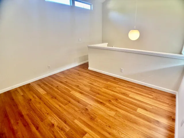 a view of a room with wooden floor