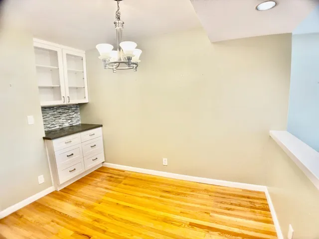 a view of kitchen cabinets and wooden floor