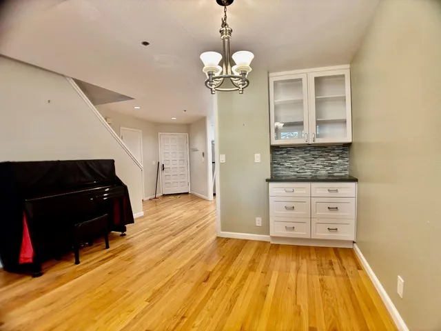 a spacious bathroom with a granite countertop sink and a mirror