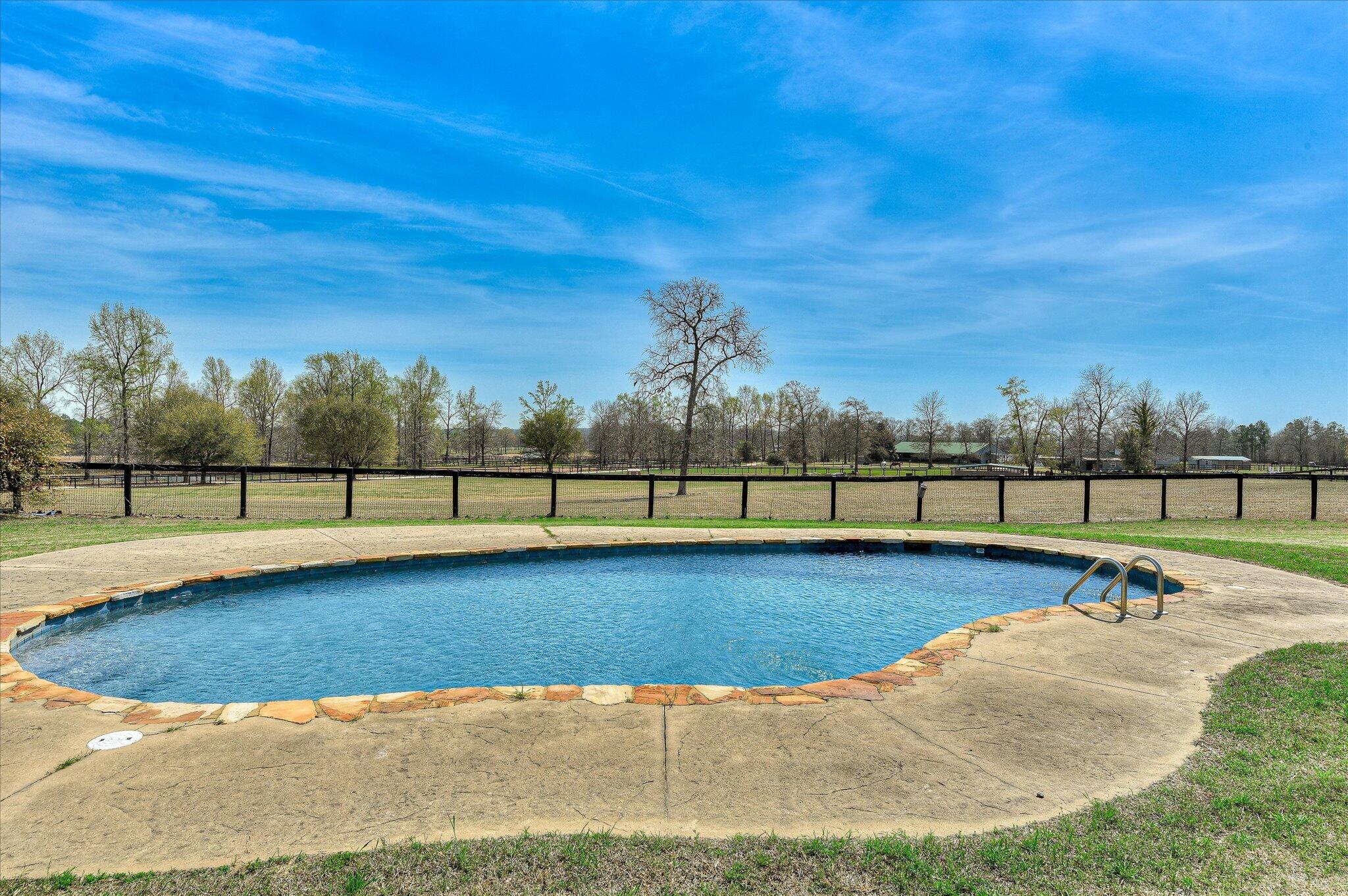 1063 Colbert Bridge Road Aiken, SC 29803 - Photo 25 of 68 a view of a swimming pool with a yard