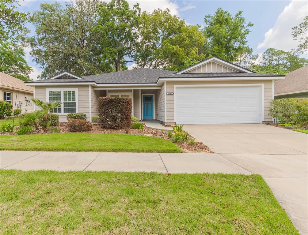 1642 Northwest 34th Avenue Gainesville, FL 32605 - Photo 1 of 14 a front view of a house with garden